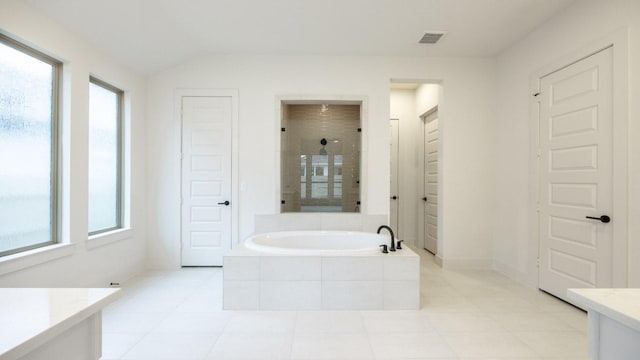 full bath with a stall shower, visible vents, a garden tub, vaulted ceiling, and a closet