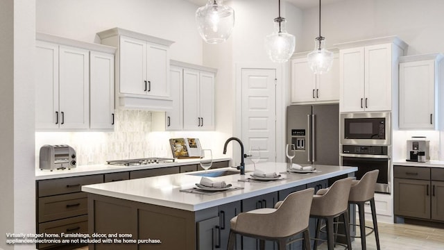 8512 Picnic House Path, Austin, TX 78744 - kitchen with stainless steel appliances, light countertops, white cabinets, and a kitchen island with sink