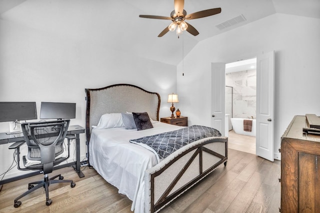 bedroom with ceiling fan, vaulted ceiling, light hardwood / wood-style flooring, and ensuite bathroom