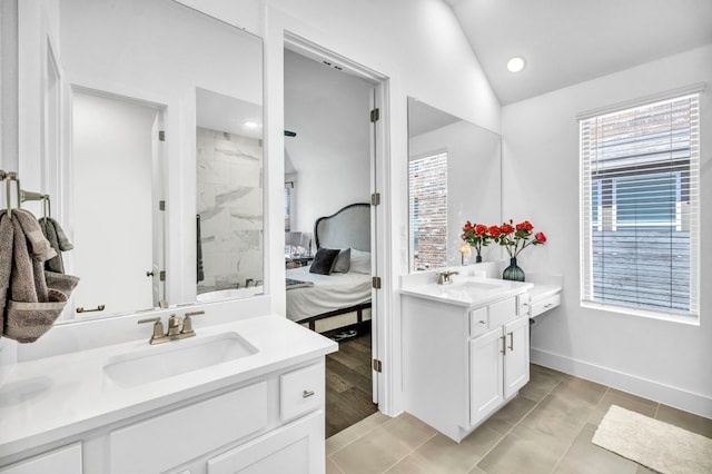 bathroom featuring tile patterned flooring, lofted ceiling, and dual bowl vanity