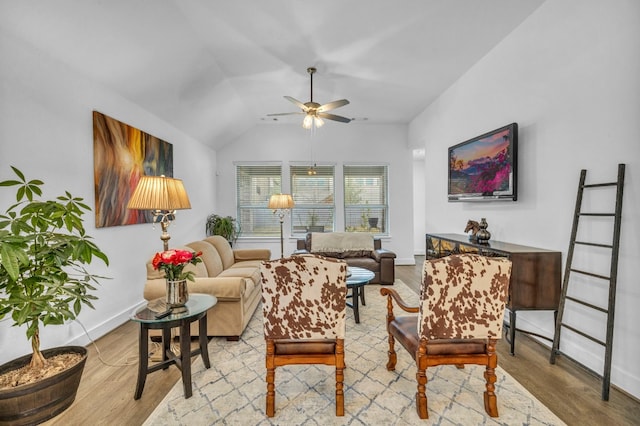 living room featuring ceiling fan, light hardwood / wood-style flooring, and lofted ceiling