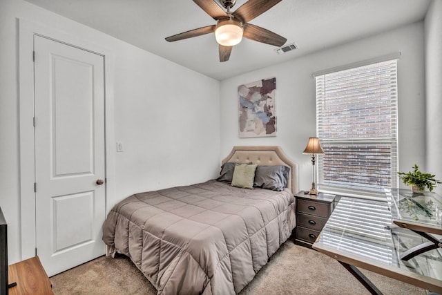 bedroom with ceiling fan and light carpet