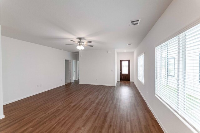 spare room with ceiling fan and dark wood-type flooring