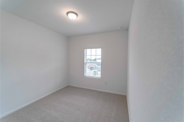 unfurnished room featuring carpet flooring