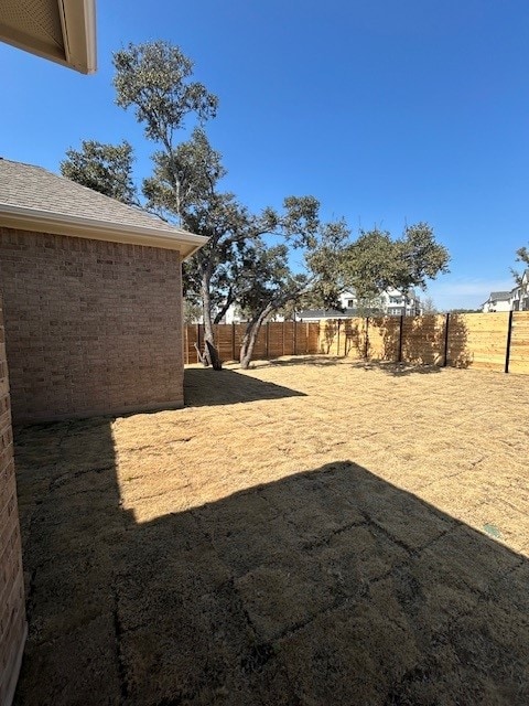 view of yard with a fenced backyard