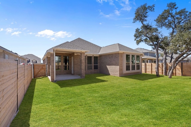 520 Raleigh Dr, Georgetown, TX 78633 - back of house with brick siding, a fenced backyard, a patio, and a shingled roof