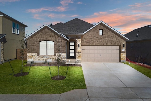 520 Raleigh Dr, Georgetown, TX 78633 - view of front facade with concrete driveway, a lawn, brick siding, and stone siding
