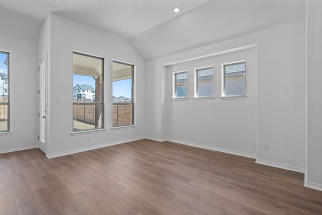 520 Raleigh Dr, Georgetown, TX 78633 - empty room featuring dark wood-style flooring, plenty of natural light, and vaulted ceiling