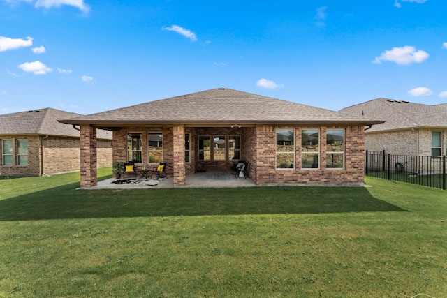 back of property with a lawn and a patio