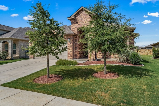 view of front of property featuring a garage and a front lawn