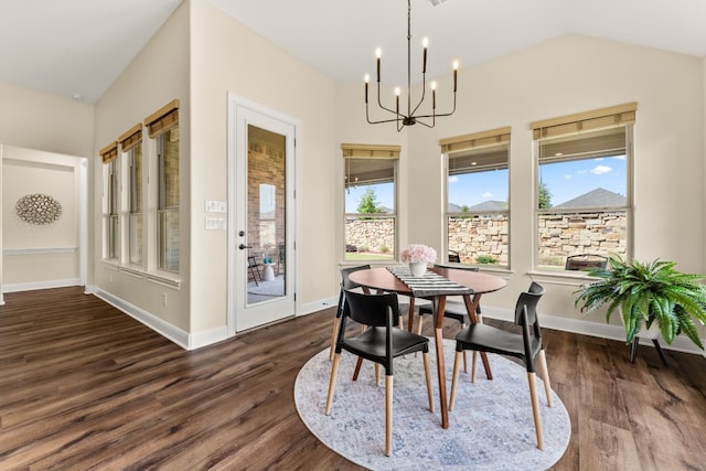 dining space with a notable chandelier, lofted ceiling, and dark wood-type flooring