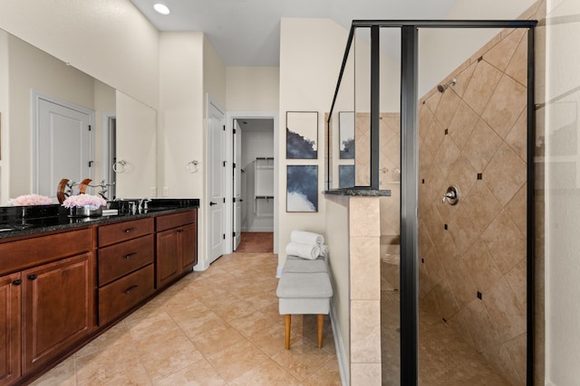 bathroom featuring vanity and a shower with door