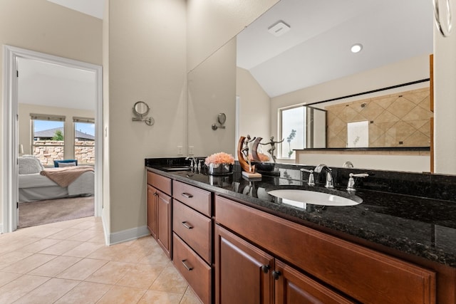 bathroom featuring tile patterned flooring, vanity, and lofted ceiling