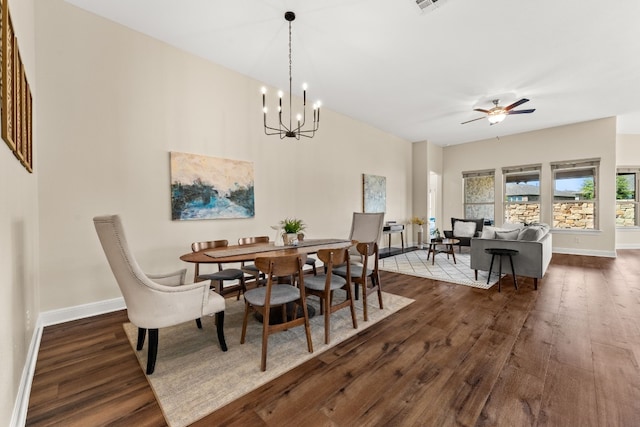 dining area featuring dark wood-type flooring and ceiling fan with notable chandelier