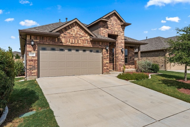 view of front of property with a front yard and a garage