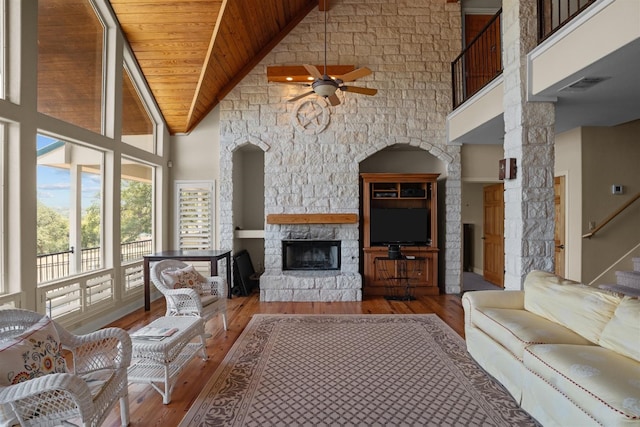 living room with ceiling fan, high vaulted ceiling, wooden ceiling, and wood-type flooring