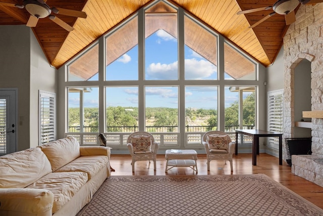 sunroom featuring ceiling fan, plenty of natural light, wooden ceiling, and vaulted ceiling