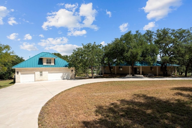 view of front facade with a garage and a front lawn