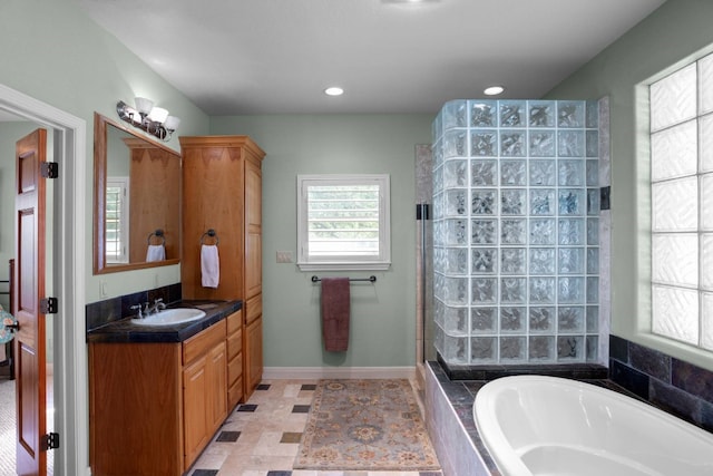 bathroom with vanity and independent shower and bath