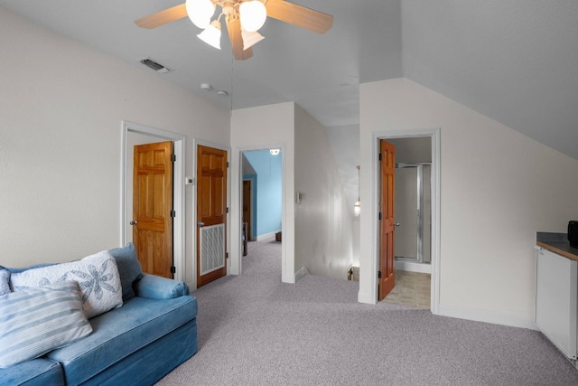 carpeted living room with ceiling fan and lofted ceiling