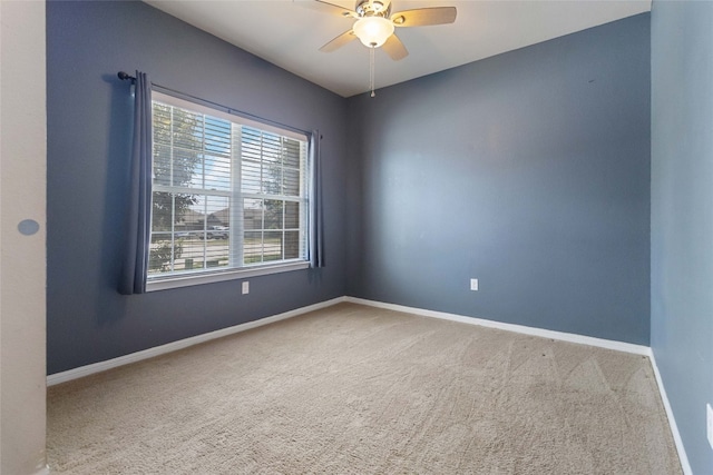 carpeted empty room featuring ceiling fan