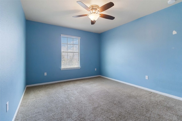 carpeted spare room with ceiling fan