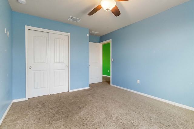 unfurnished bedroom with a closet, ceiling fan, and carpet floors