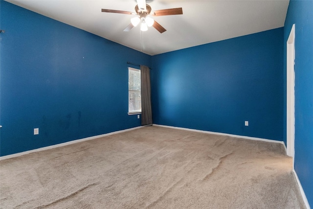 spare room featuring ceiling fan and carpet flooring