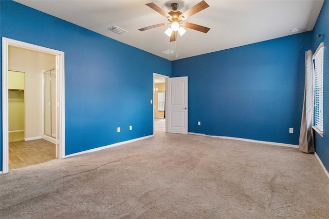 carpeted empty room featuring ceiling fan