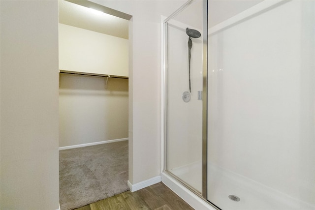 bathroom featuring wood-type flooring and walk in shower