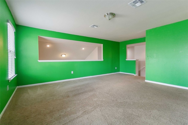 carpeted spare room with a wealth of natural light