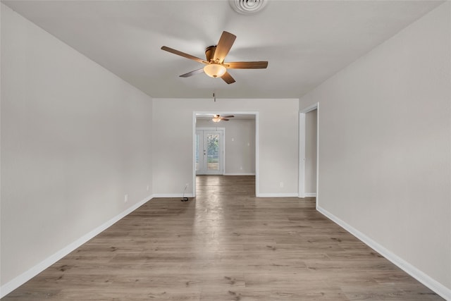 unfurnished room with ceiling fan and wood-type flooring