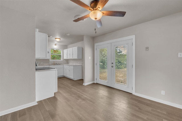 kitchen featuring french doors, light wood-type flooring, ceiling fan, and white cabinetry