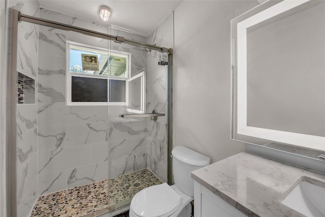 bathroom featuring walk in shower, toilet, and vanity