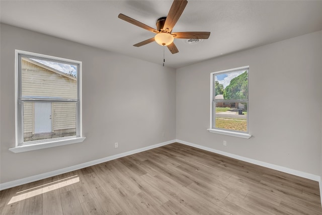 empty room featuring light wood-type flooring and ceiling fan