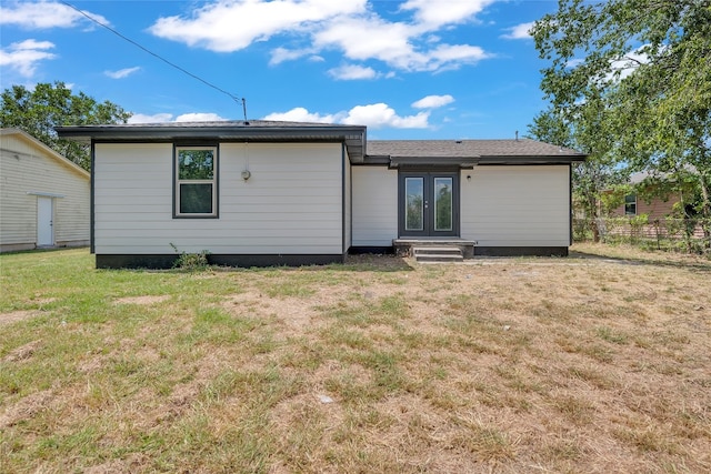 rear view of property featuring a yard