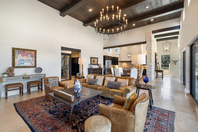 tiled living room featuring beamed ceiling, wooden ceiling, a high ceiling, and an inviting chandelier