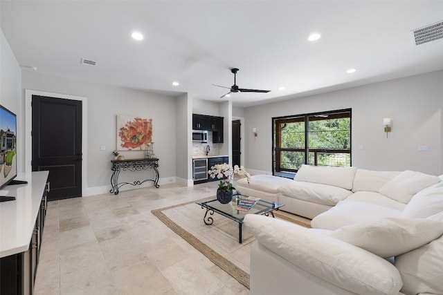 living room featuring ceiling fan, beverage cooler, and light tile patterned floors