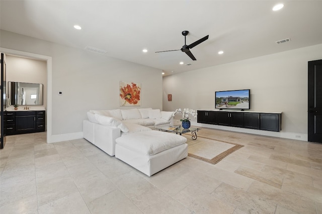 tiled living room with ceiling fan