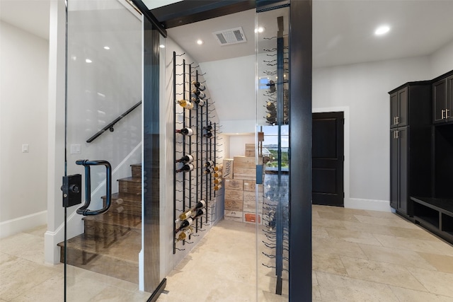 wine cellar featuring light tile patterned flooring and a barn door