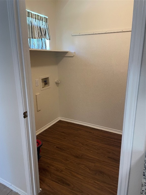 clothes washing area featuring dark hardwood / wood-style floors and washer hookup