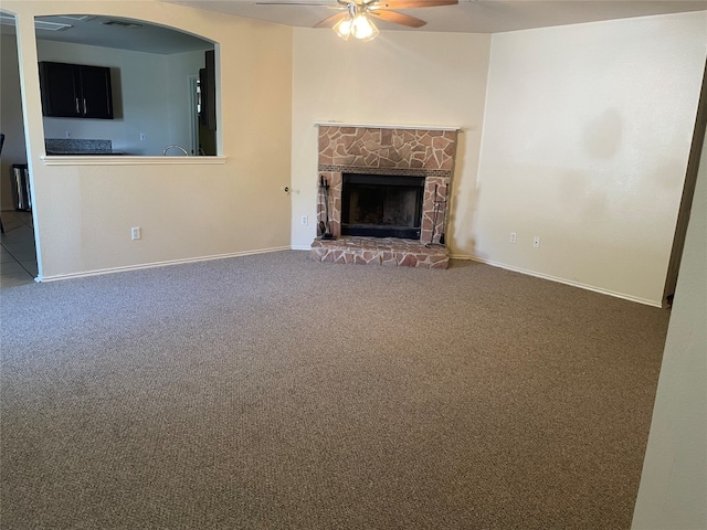 unfurnished living room featuring ceiling fan and carpet