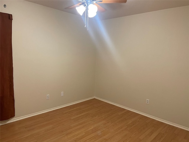 empty room with ceiling fan and hardwood / wood-style floors