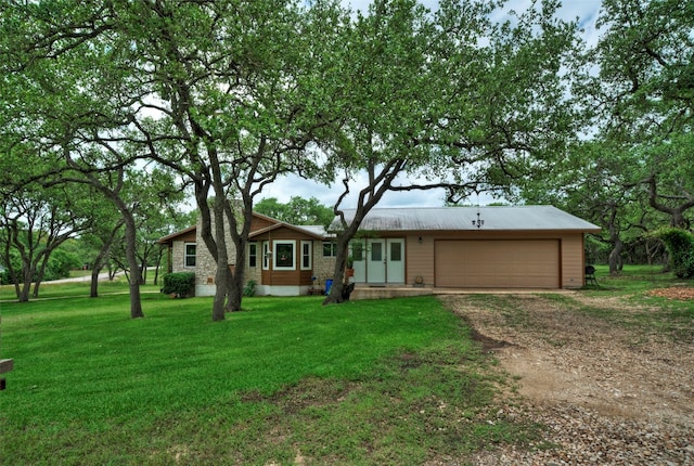 ranch-style house with a garage and a front lawn