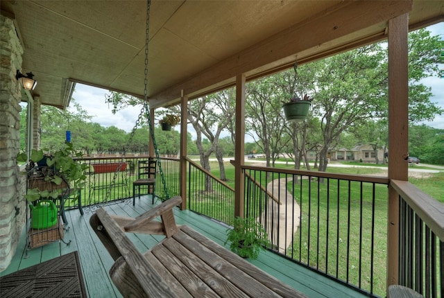 wooden terrace with a yard