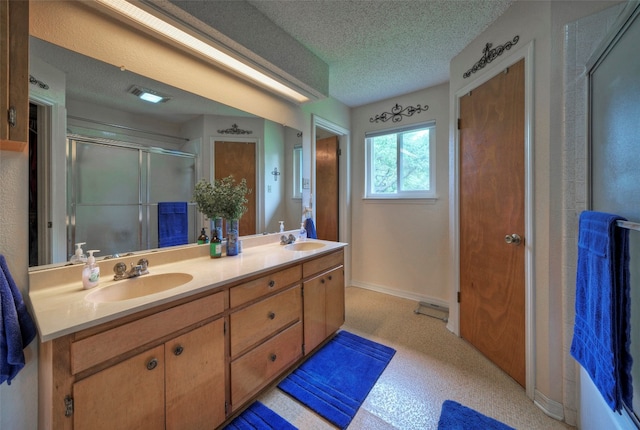 bathroom featuring a textured ceiling and vanity