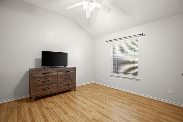 unfurnished bedroom with ceiling fan, light wood-type flooring, and vaulted ceiling