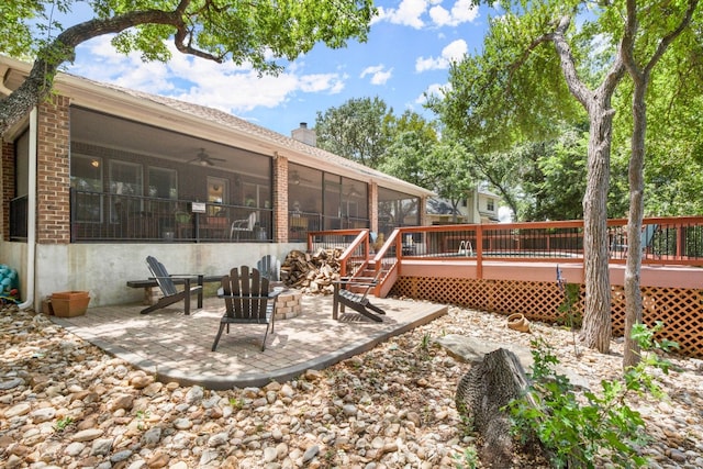 view of yard featuring a wooden deck, a patio, and a sunroom