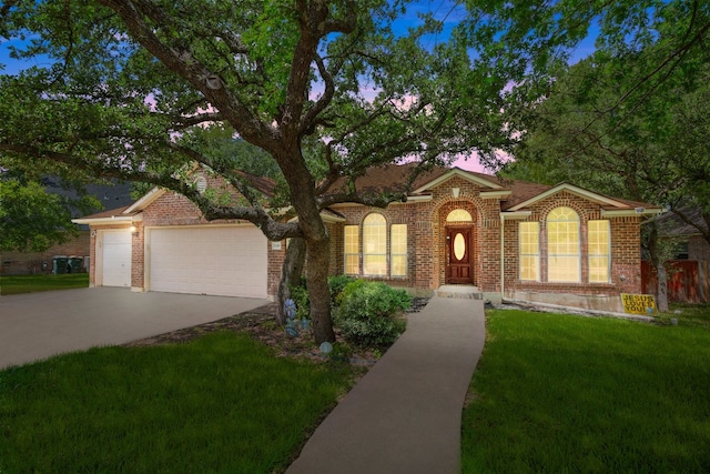 view of front of property featuring a yard and a garage