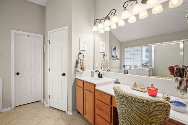 bathroom with tile patterned floors, vanity, and vaulted ceiling